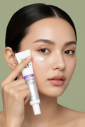 Model applying Anua Retinol 0.1+ Caffeine Revitalizing Eye Cream on army green background