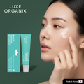 Luxe Organix Miracle Solutions Spot Corrector on army green background with model
